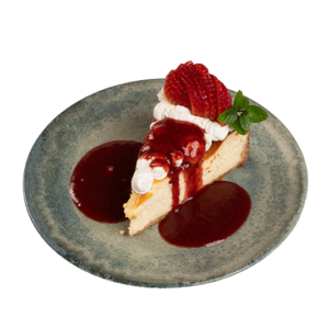Creamy strawberry cheesecake slice garnished with fresh strawberries, whipped cream, and strawberry sauce.