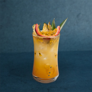 Refreshing summer coconut drink with tropical fruit garnish, served over ice in a tall glass.