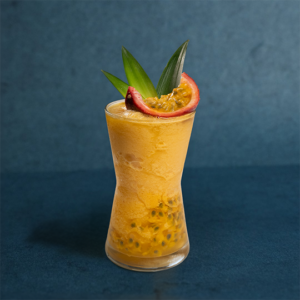 Chilled passion fruit drink in a tall glass, featuring a vibrant golden color and fresh presentation.