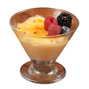Vanilla custard with a caramelized sugar crust, topped with raspberries, blackberry, and blueberry in a glass dessert cup.