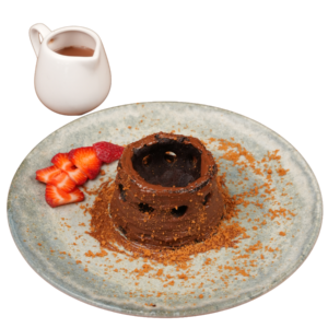 Warm chocolate volcano cake with a molten center, served with sliced strawberries, biscuit crumbs, and chocolate sauce on the side.